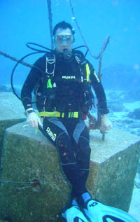 Claus on a cement block acting as an anchor for the dive markers