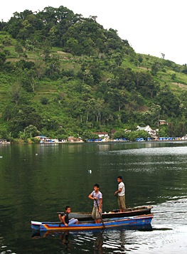 Boys rowing on Lake Toba